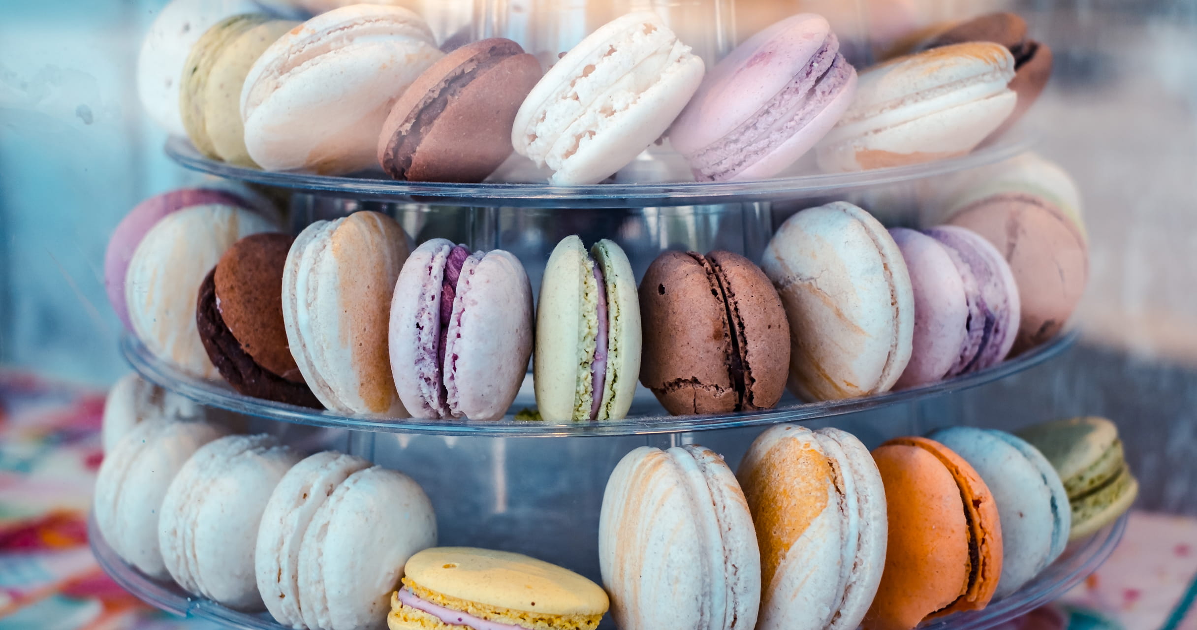 A display of colourful Macrons in a store window.